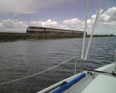 Sailing near Discovery Bay with Amtrak crossing the causeway